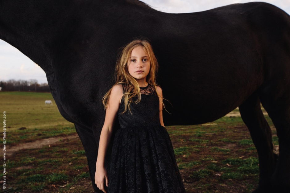 Teslyn - Beautiful Young Girl Leaning Back on Black Draft Horse