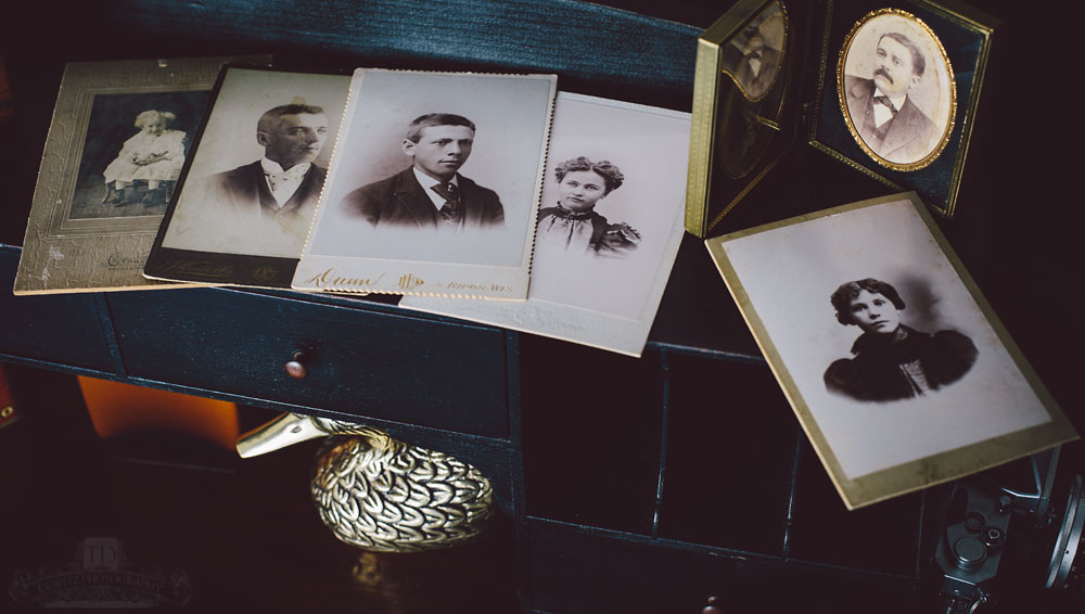 Vintage Caninet Cards on Black Desk With Antique Framed Portraits