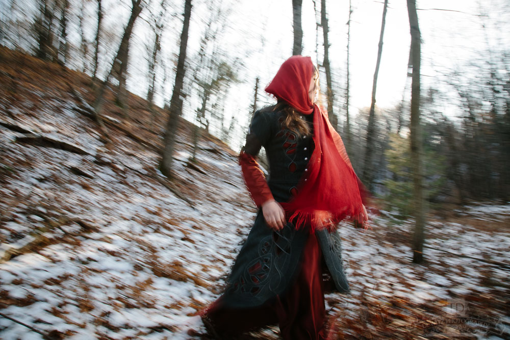 Red Riding Hood Running from Wolf Through the Woods