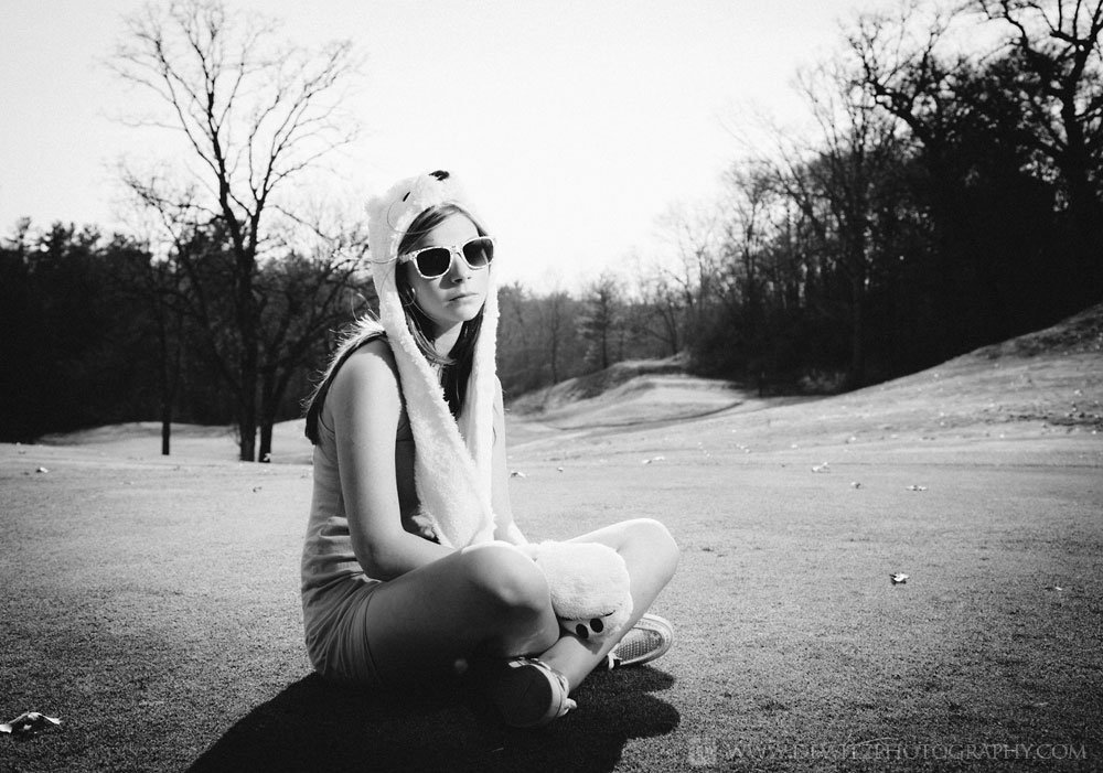 alexa_sitting_on_golf_course_green_bear_hat_and_shades