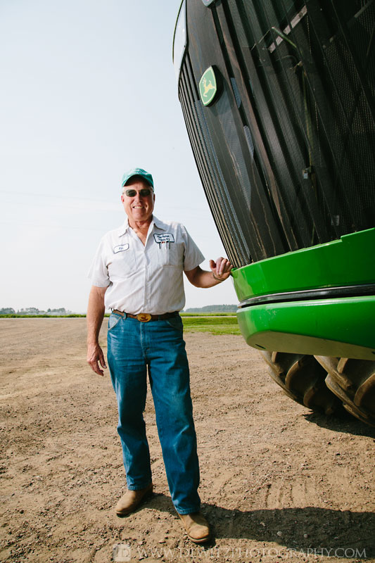 rine_farms_ken_standing_next_to_john_deere_tractor