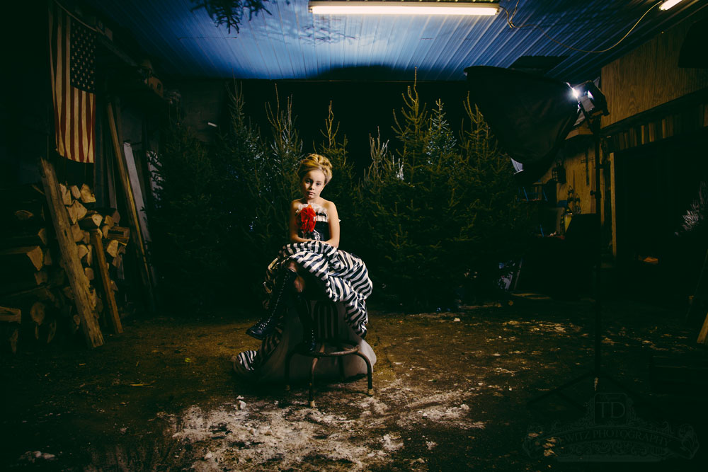 Teslyn in shed with trees sitting on stool