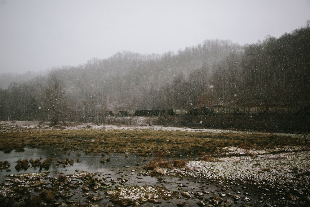 coal_train_along_marsh_during_snowfall_web