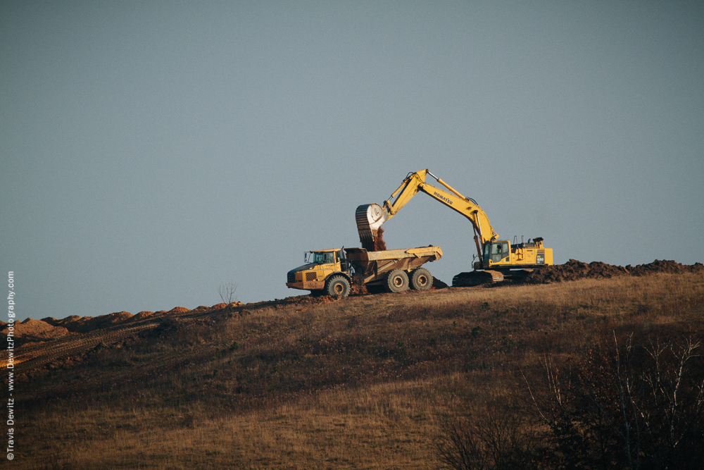 Excavator Loading Sand into Large Heavy Haul Truck