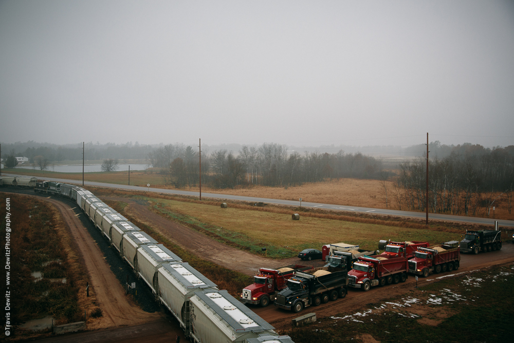 Sand Trucks Wait for Train