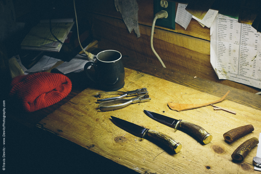 Pair of Hunting Knifes on Bench Along with a Blaze Orange Hat and Coffee Cup