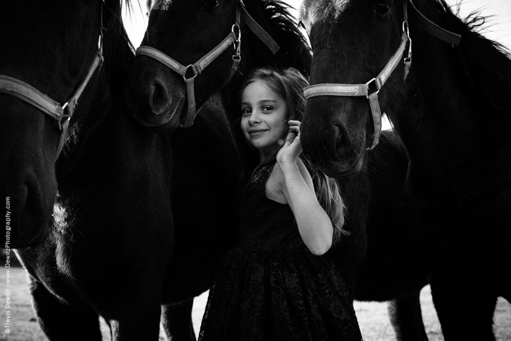 Teslyn - Happy Little Girl in Between Young Horses