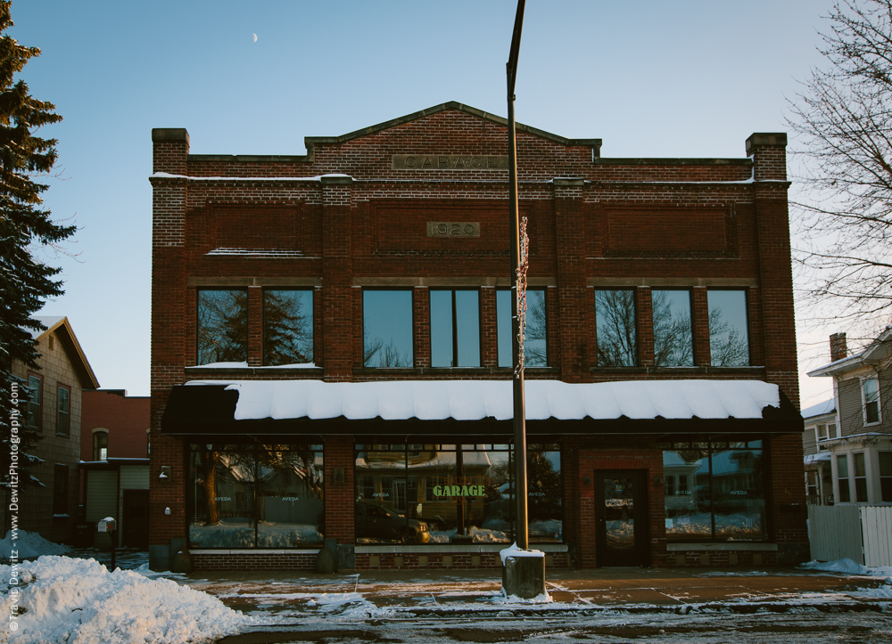 The building was originally an automobile dealer and then was also used by the Chippewa Falls Armory and had also served the Chippewa Falls School District as a bus garage. Now it is the Garage Salon. 