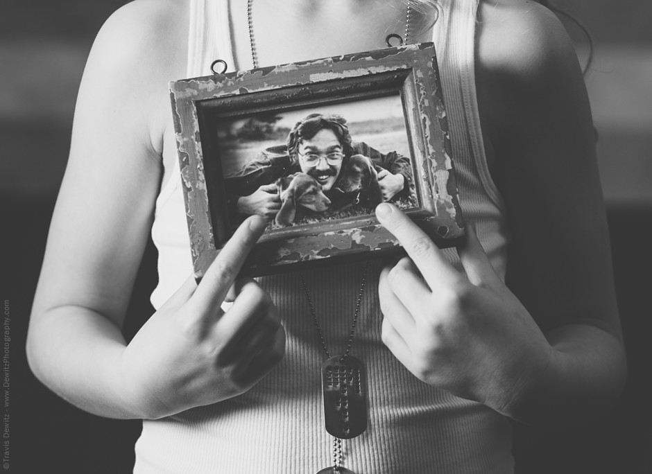 Teslyn Holding Framed Photo of Her Papa Mark with Dogs