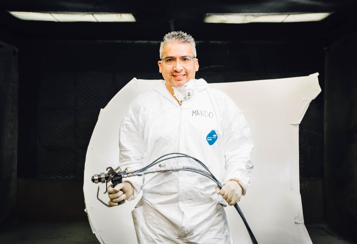 fivestarfabricatingpainterinpaintboothholdingspraygunhood