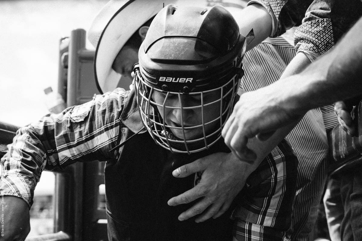 Bull Rider in Helmet Gets on Bull in Chute-2984