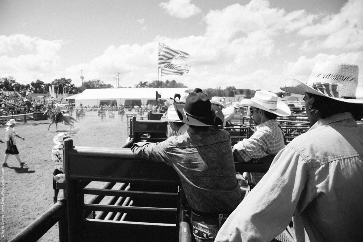 Cowboys Watch over Bull Riding in Arena-3137
