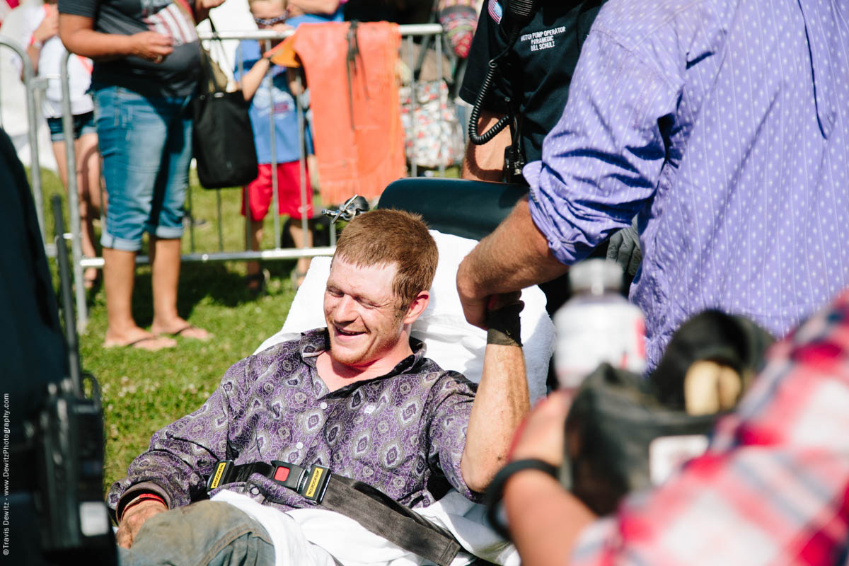 70-Injured Bull Rider on Stretcher Holds Friends Hand-3386