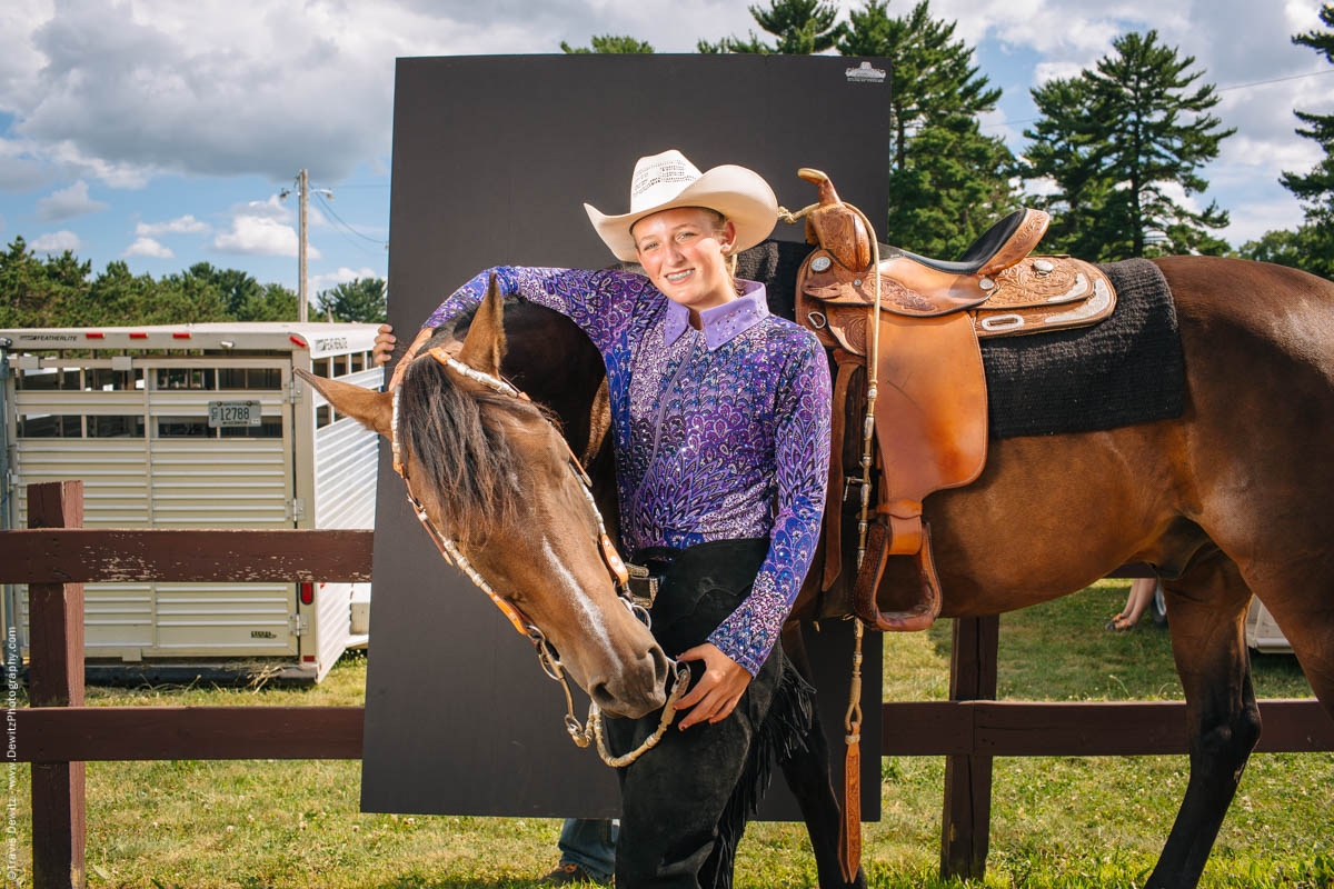 teen-cowgirl-poses-holding-horse-by-fence-portrait-northern-wisconsin-state-fair-2222
