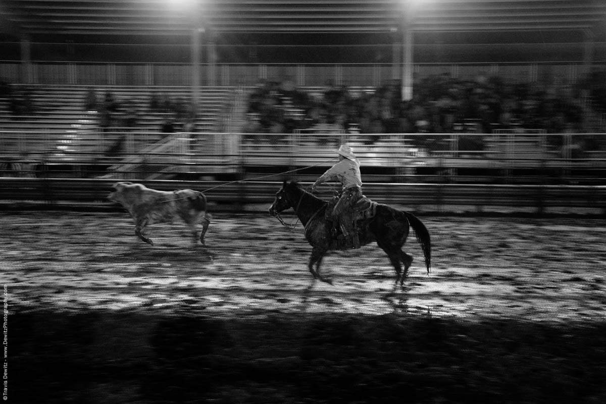 cowboy-lassos-running-bull-in-muddy-arena-rice-bull-riding-black-river-falls-wi-5400