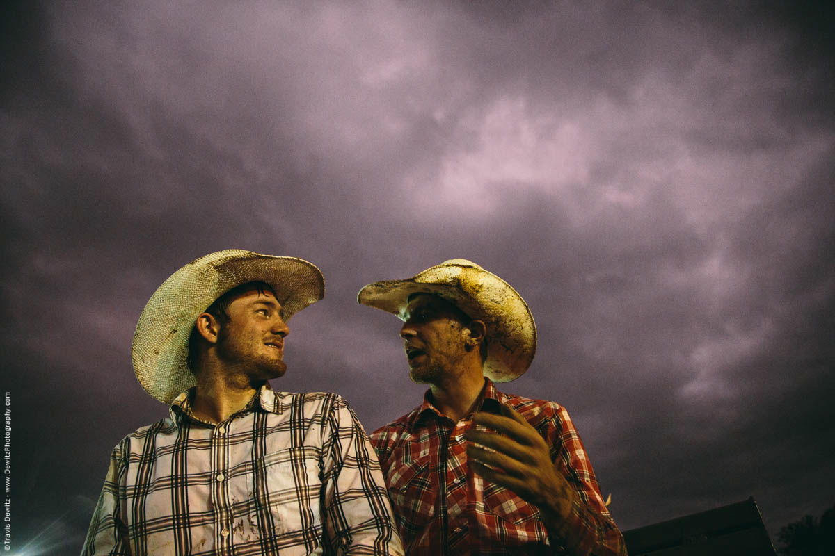 two-cowboys-talk-rodeo-stormy-skies-western-shirts-covered-in-mud-night-5179